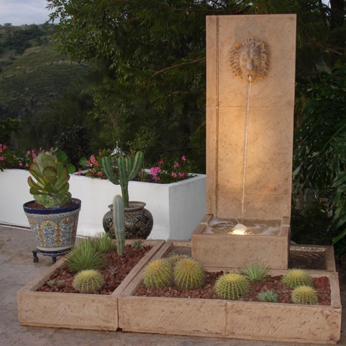 Fuente Basino iluminada con macetas alrededor